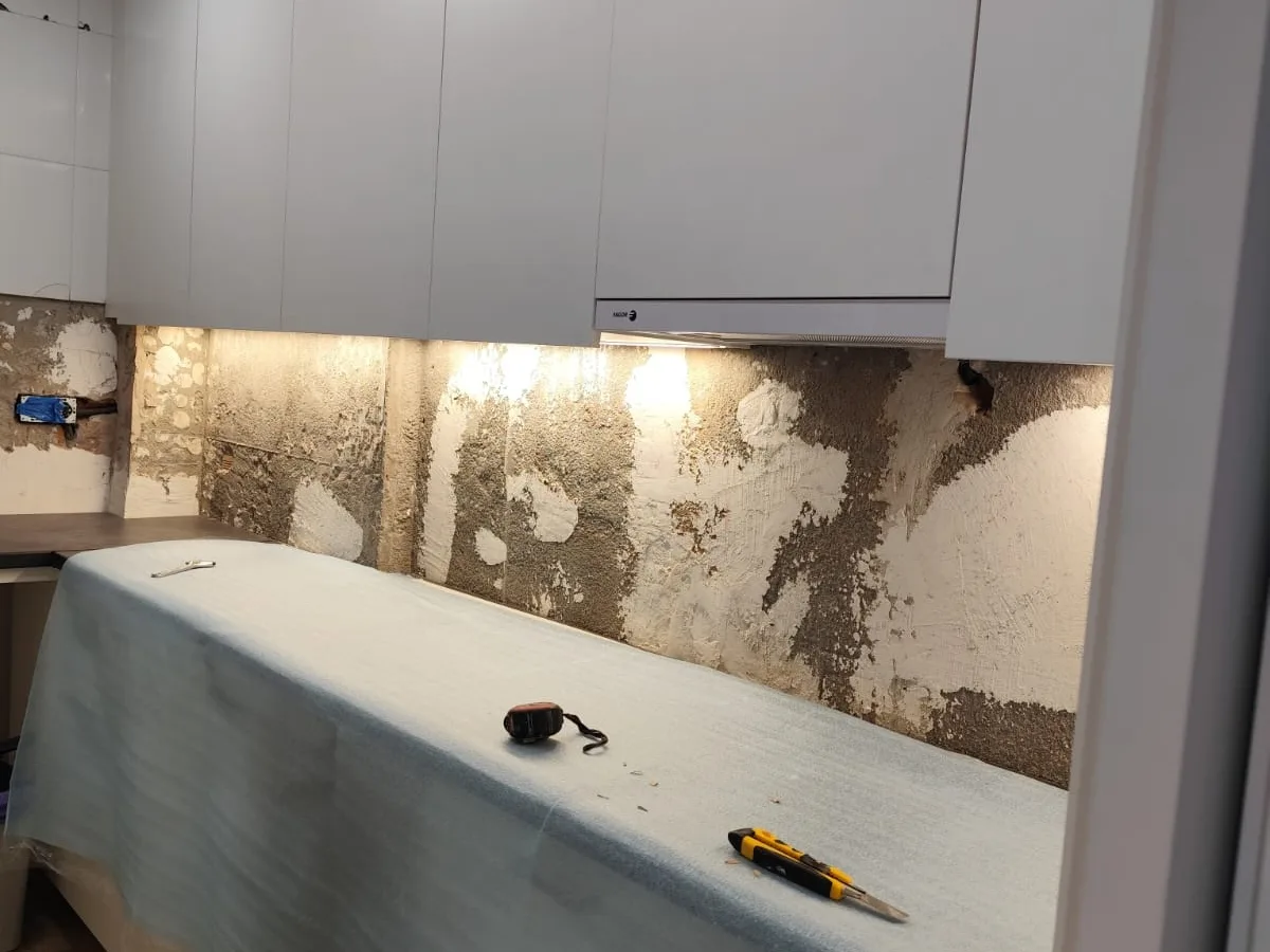 Montaje de los muebles y la encimera de una cocina durante una reforma en Barcelona